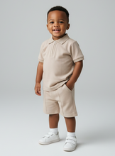 Load image into Gallery viewer, 2 year old in beige polo set - casual pose
