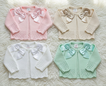 Load image into Gallery viewer, All four cardigans flat lay on fluffy rug