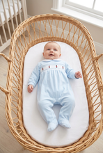 Load image into Gallery viewer, Angled baby model view in a wicker Moses basket