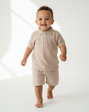 Load image into Gallery viewer, Baby boy in beige polo set - walking