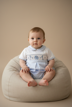 Load image into Gallery viewer, Baby boy in blue gingham elephant romper sitting on beige beanbag