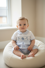 Load image into Gallery viewer, Baby boy in blue gingham elephant romper sitting on cream beanbag