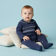 Load image into Gallery viewer, Baby boy in navy smocked babygrow - sitting with cushions