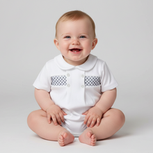 Load image into Gallery viewer, Baby boy in white smocked romper - sitting