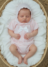 Load image into Gallery viewer, Baby girl in pink knit set - Moses basket overhead 2