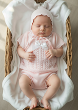 Load image into Gallery viewer, Baby girl in pink knit set - wicker basket overhead 1
