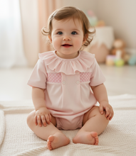 Load image into Gallery viewer, Baby girl in pink smocked romper - On blanket