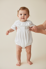 Load image into Gallery viewer, Baby girl in white smocked romper - Standing