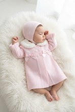 Load image into Gallery viewer, Baby girl modelling pink coat and bonnet on a white fluffy rug