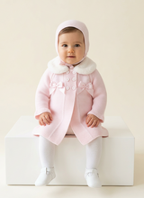Load image into Gallery viewer, Baby girl seated at a slight angle on a white cube