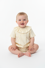 Load image into Gallery viewer, Baby girl sitting in lemon romper - Plain white