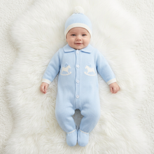 Load image into Gallery viewer, Baby in blue lying on a white fluffy rug