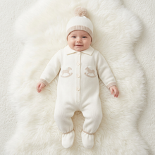 Load image into Gallery viewer, Baby in cream on a large white fluffy rug