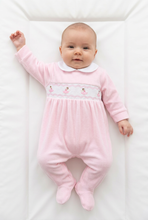 Load image into Gallery viewer, Baby in the pink sleepsuit stretching one arm upward