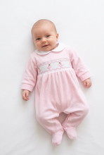 Load image into Gallery viewer, Baby in the pink sleepsuit with head turned and legs softly bent