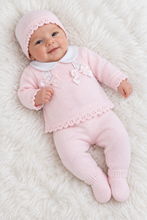 Load image into Gallery viewer, Baby model wearing pink knitted outfit in angled professional photograph