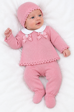 Load image into Gallery viewer, Baby model wearing the pink knitted outfit in a white studio
