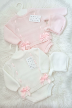 Load image into Gallery viewer, Baby outfits on a large white fluffy rug, with the white set brightened to a cleaner white