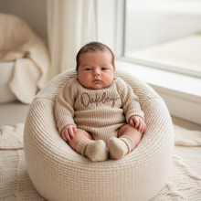 Load image into Gallery viewer, Baby propped on beanbag nest in Oakley romper