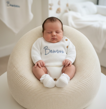 Load image into Gallery viewer, Baby propped on beanbag nest in white romper