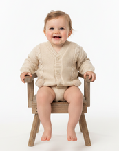 Load image into Gallery viewer, Cream cardigan baby girl legs dangling