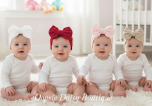 Load image into Gallery viewer, Four babies in onesies with bow headbands