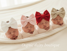 Load image into Gallery viewer, Four babies with bow headbands lying down