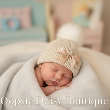 Load image into Gallery viewer, Newborn baby in cream hat with centered ribbon bow