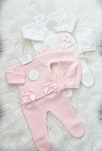 Load image into Gallery viewer, Pink and bright white knitted outfits on a large white fluffy rug