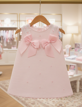 Load image into Gallery viewer, Pink dress on wooden hanger in shop