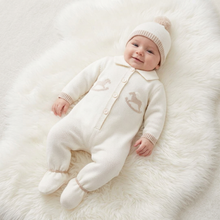 Load image into Gallery viewer, Smiling baby in cream on a large white fluffy rug