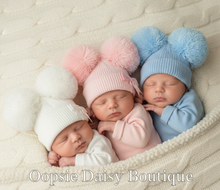Load image into Gallery viewer, Three babies with pom-pom hats lying down