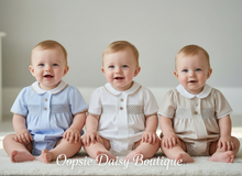 Load image into Gallery viewer, Three baby boys in blue, white, and beige rompers