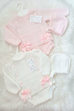 Load image into Gallery viewer, White outfit and bonnet brightened to clean white on the fluffy rug, with pink details preserved